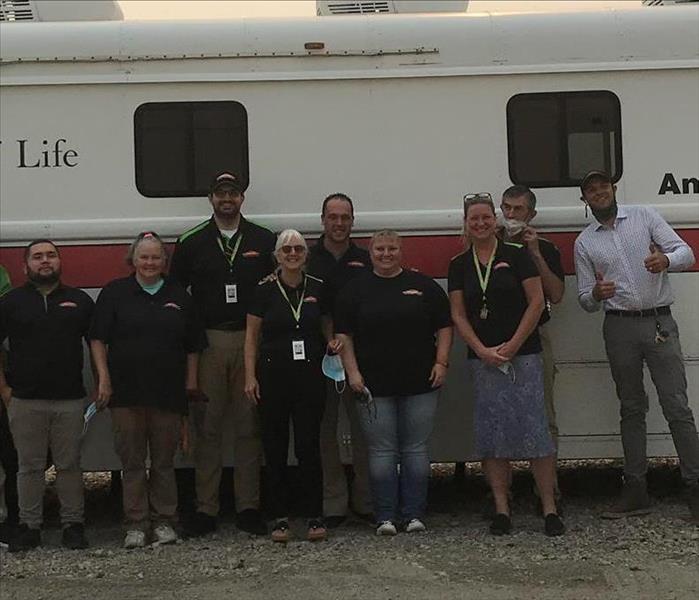 Crew standing in front of RED Cross Bus